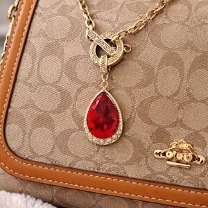 Elegant Gold Pendant with Red Gemstone